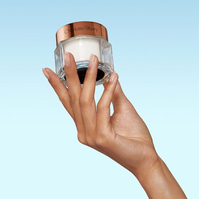 Model holding Charlotte's Magic Cream immediate skin revival moisturiser