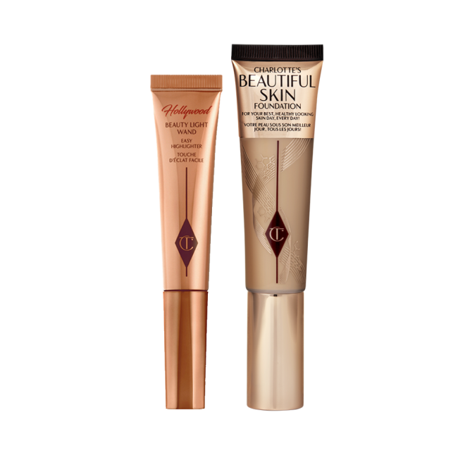 Highlighter wand in light gold-coloured packaging with a foundation wand in gold packaging with a ashy brown-beige-coloured body to show the shade of the foundation inside, and a gold-coloured lid.