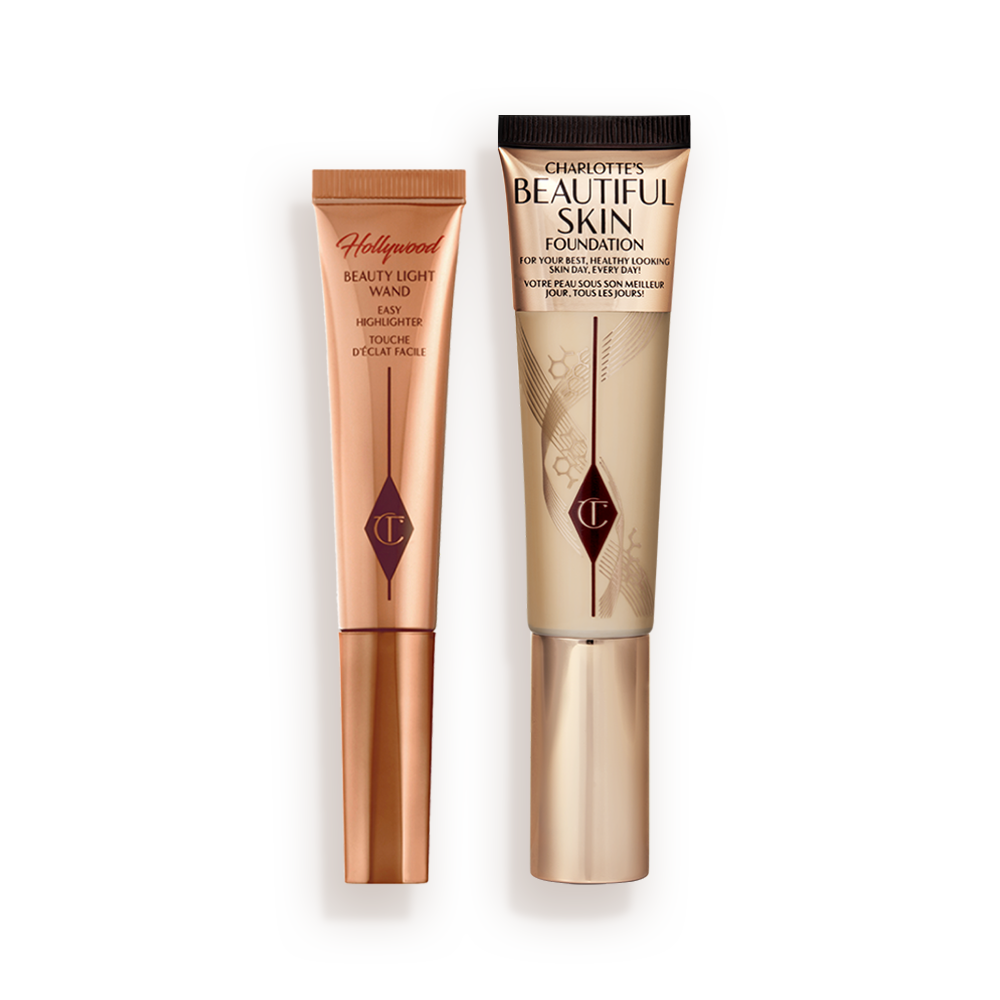 Highlighter wand in light gold-coloured packaging with a foundation wand in gold packaging with a ashy brown-beige-coloured body to show the shade of the foundation inside, and a gold-coloured lid.