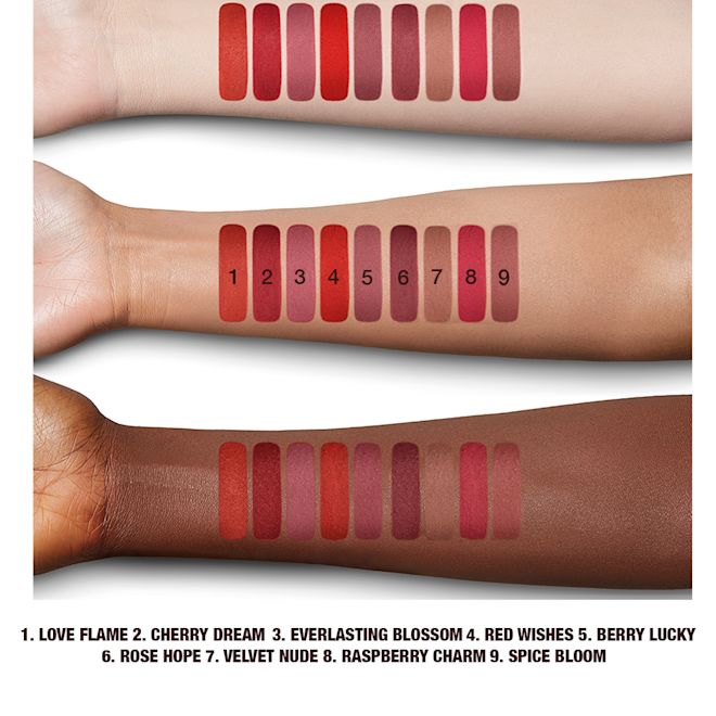 Limitless Lucky Lips collection arm swatches Arm swatches of 5, universally-flattering red-toned lipsticks with a matte finish in shades called, 'Love flame, cherry dream, everlasting blossom, red wishes, and berry lucky'.