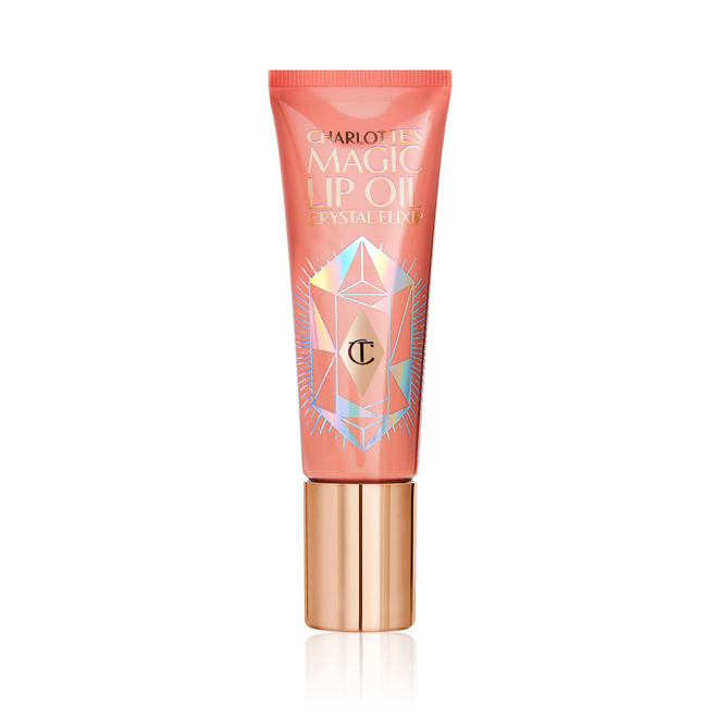 A light coral-coloured lip oil tube with a gold-coloured lid. 