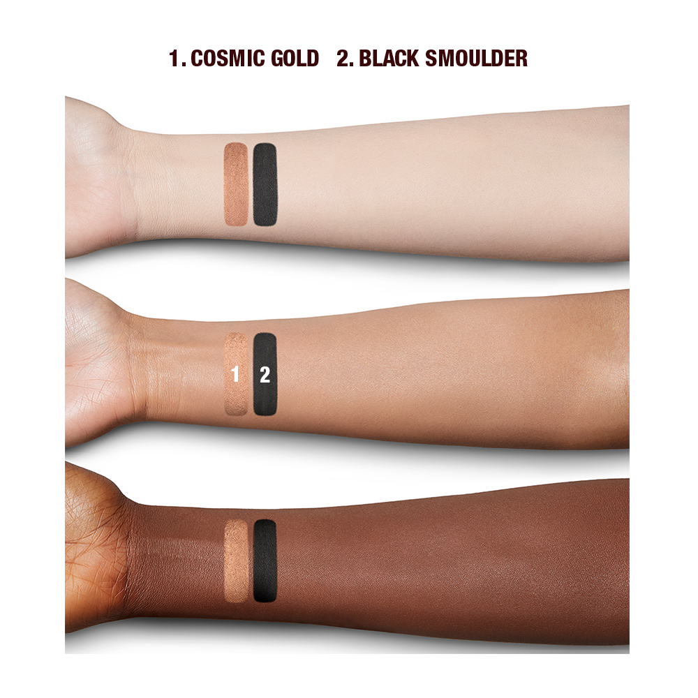 Deep, fair, and tan-tone arms with swatches of two eyeshadows in brown-gold with a metallic finish and jet black with a matte finish.