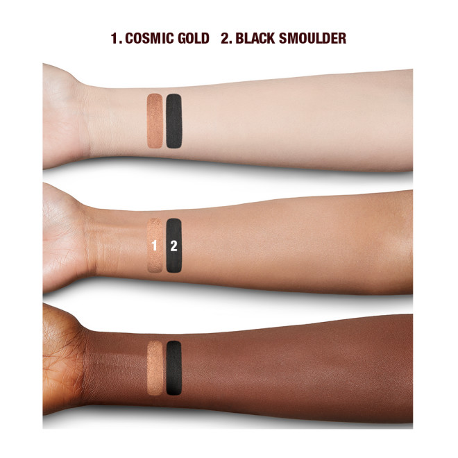 Deep, fair, and tan-tone arms with swatches of two eyeshadows in brown-gold with a metallic finish and jet black with a matte finish.