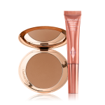 An open, mirrored-lid bonzer compact with a warm-brown bronzer and a highlighter-blush wand in a warm pink shade. 