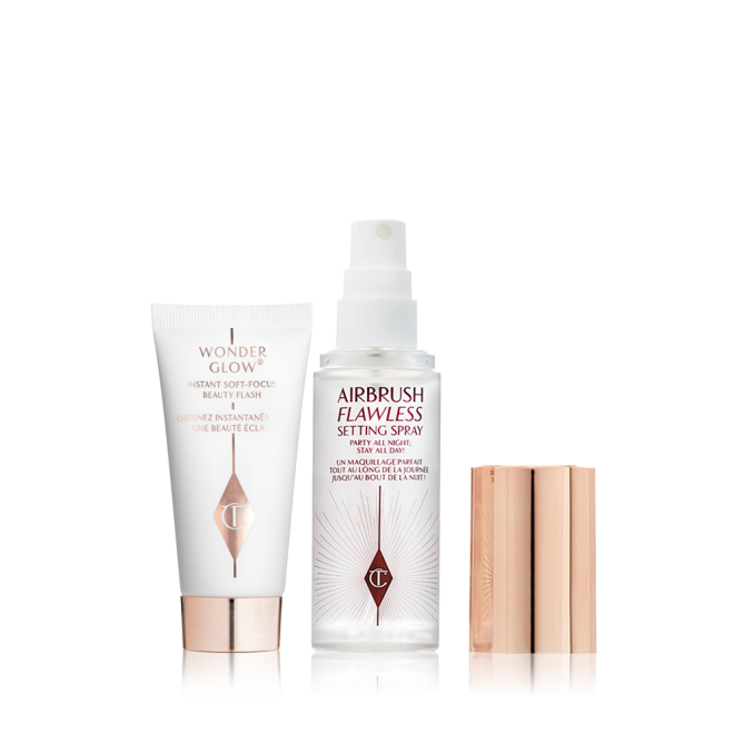 Travel size primer in a white-coloured tube with rose-gold-coloured and a travel-size setting spray in a clear bottle with gold-coloured lid.