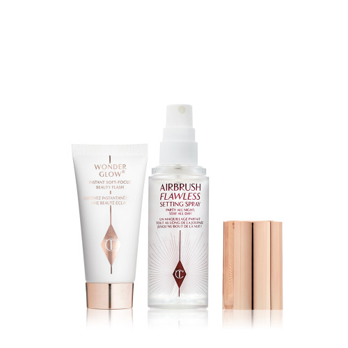 Travel size primer in a white-coloured tube with rose-gold-coloured and a travel-size setting spray in a clear bottle with gold-coloured lid.