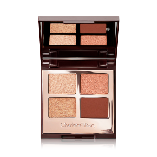 An open, mirrored-lid, quad eyeshadow palette with matte and shimmery eyeshadows in shades of copper and champagne. 