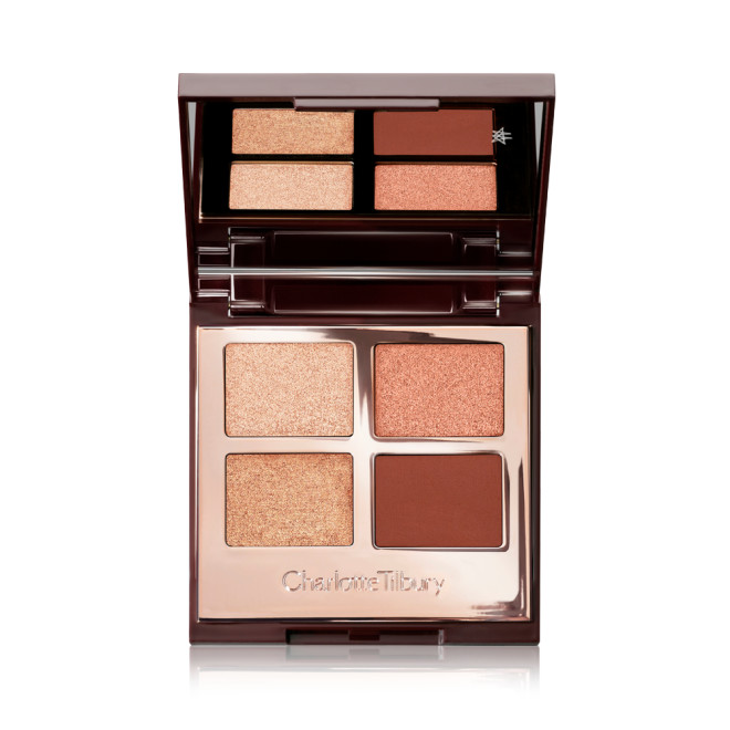 An open, mirrored-lid, quad eyeshadow palette with matte and shimmery eyeshadows in shades of copper and champagne. 