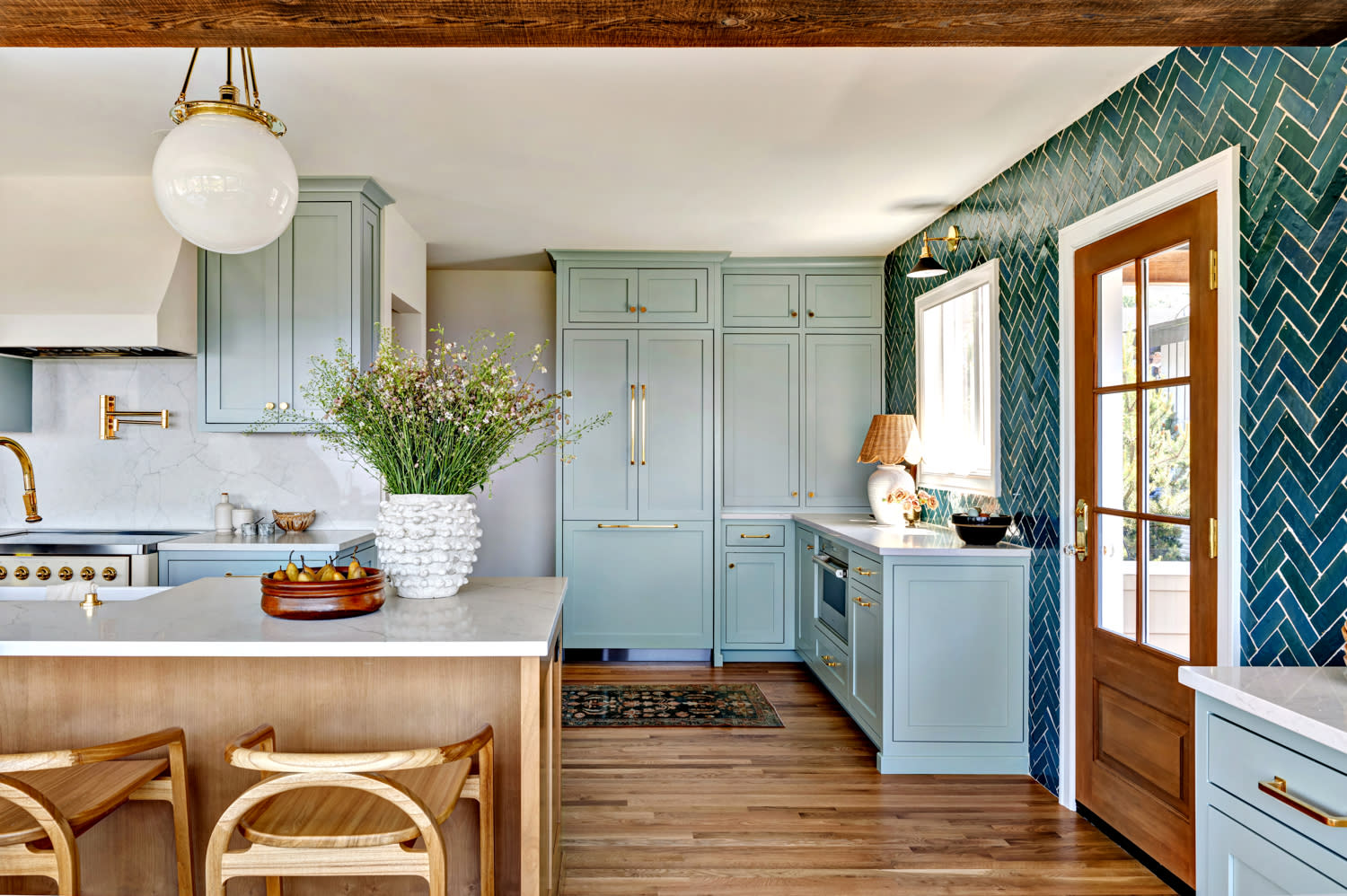 classic kitchen with blue herringbone zellige tiles and light blue cabinetry