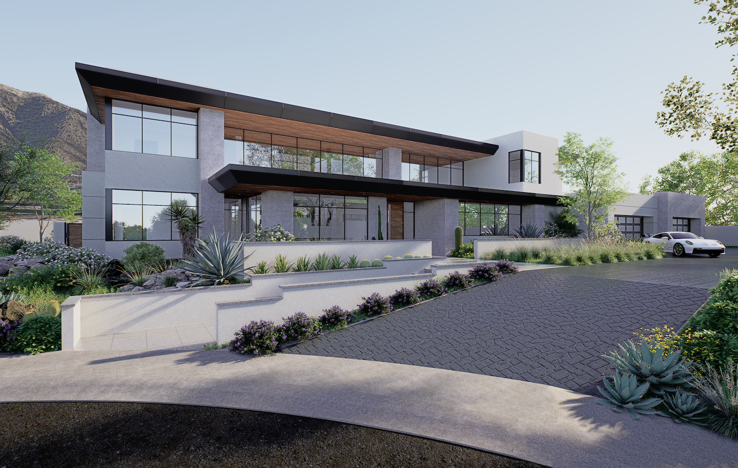 Striking two-story desert-contemporary home with wide black-edged rooflines and floor-to-ceiling glass, blending warm wood soffits and pale stucco against rugged mountain slopes. Terraced planters brimming with agave, yucca, and flowering desert shrubs cascade toward a dark herringbone paver drive, where a white sports car waits by the detached garage. Steps lead to a glass entry tucked under a bold cantilever, giving the façade a sleek, resort-like feel.