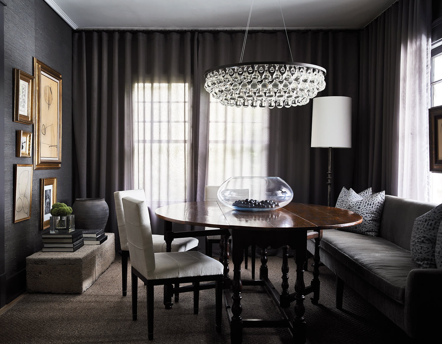 A dining room featuring a large chandelier above an elegant table