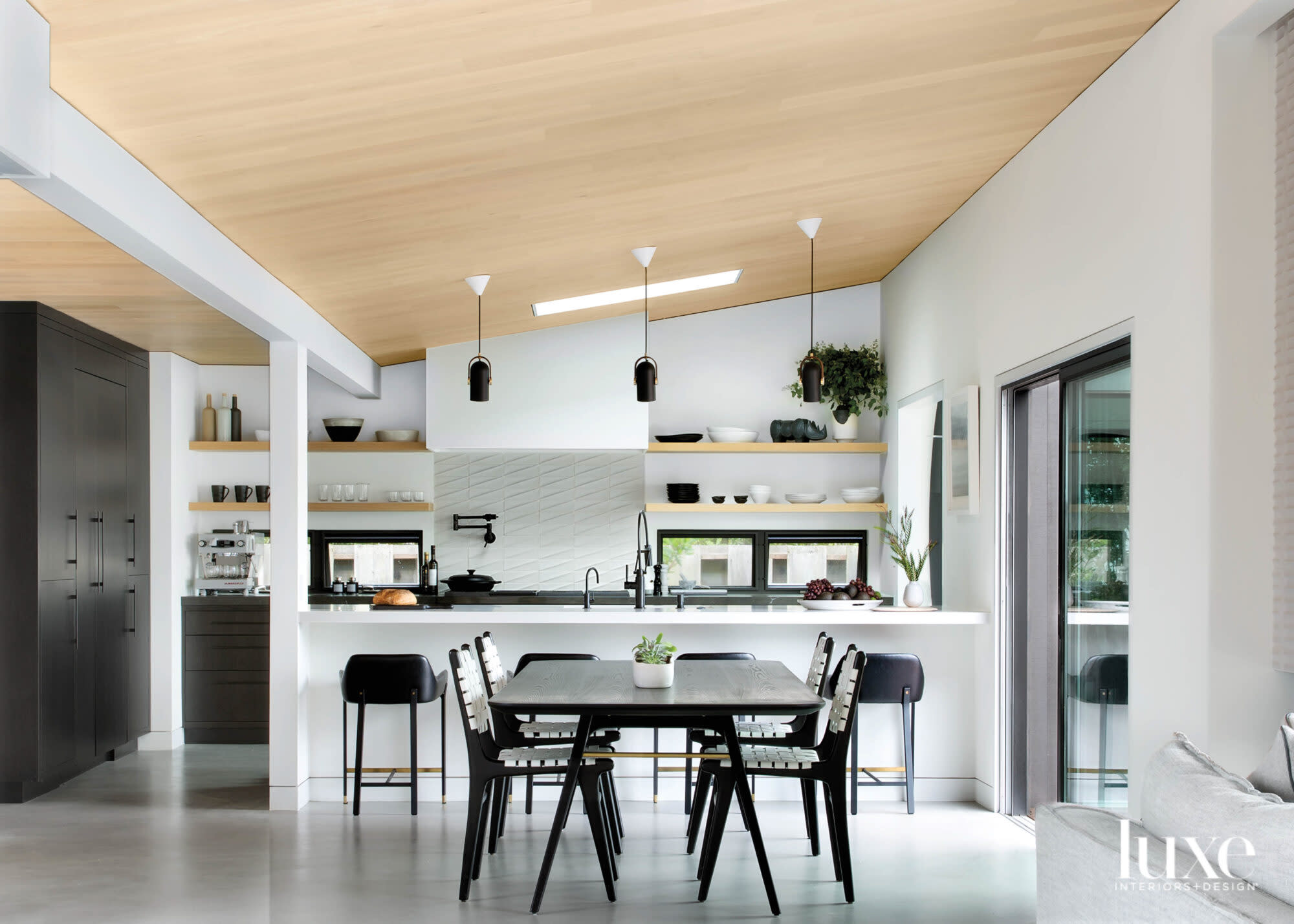 neutral kitchen with black accents and pattern backsplash