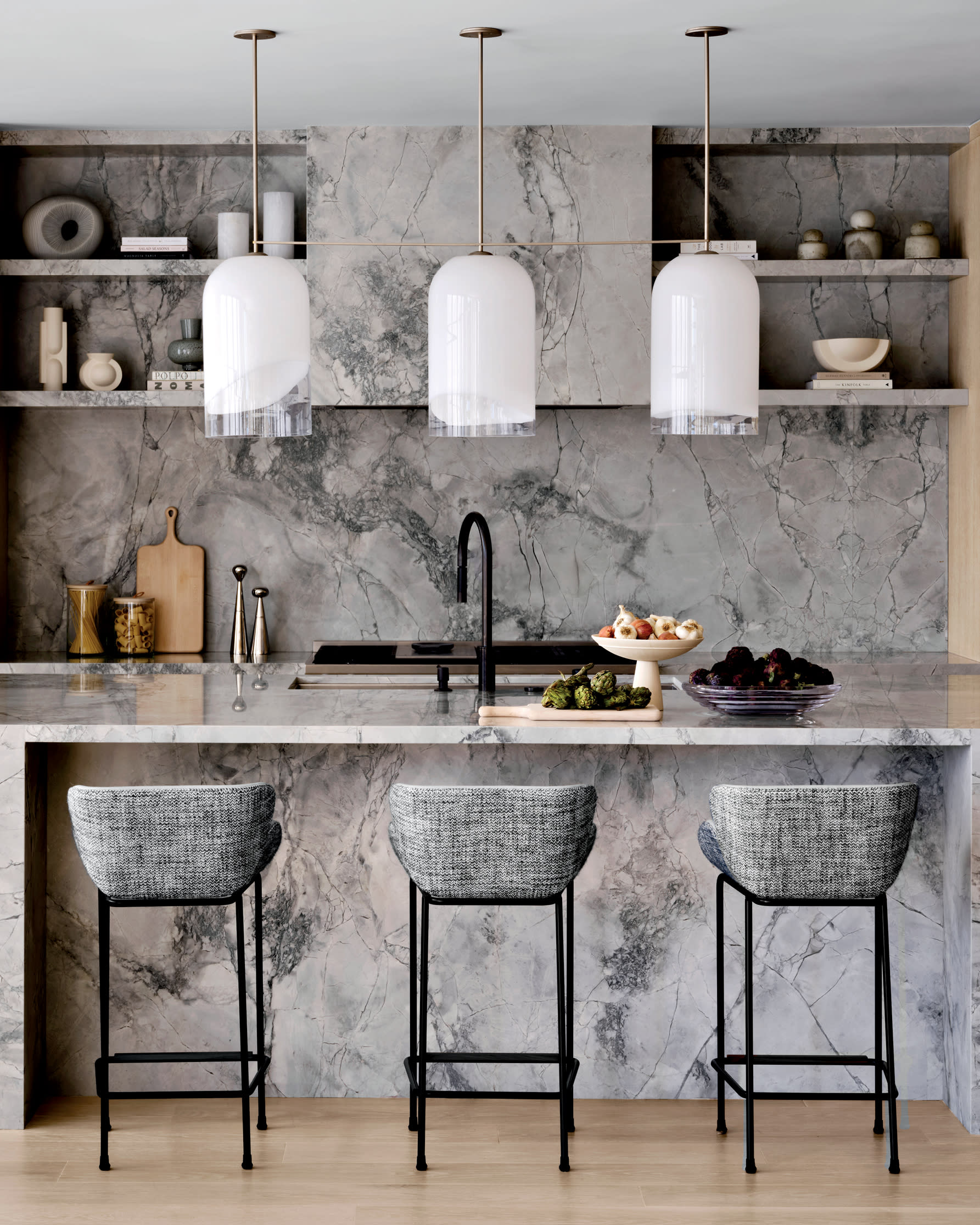 kitchen island, counters, walls, shelving and hood all covered in white quartzite