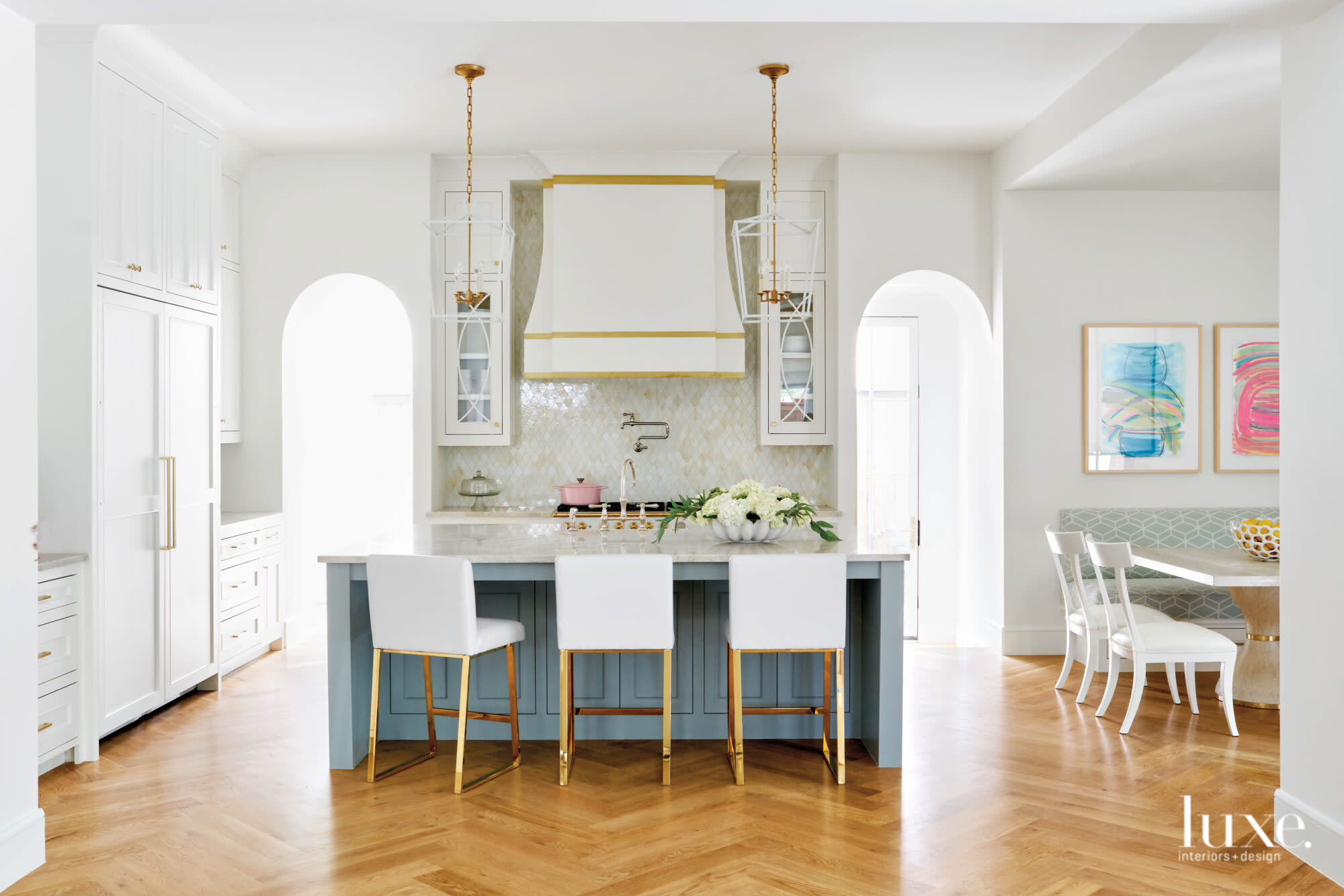 Cheerful kitchen with statement venthood and backsplash.