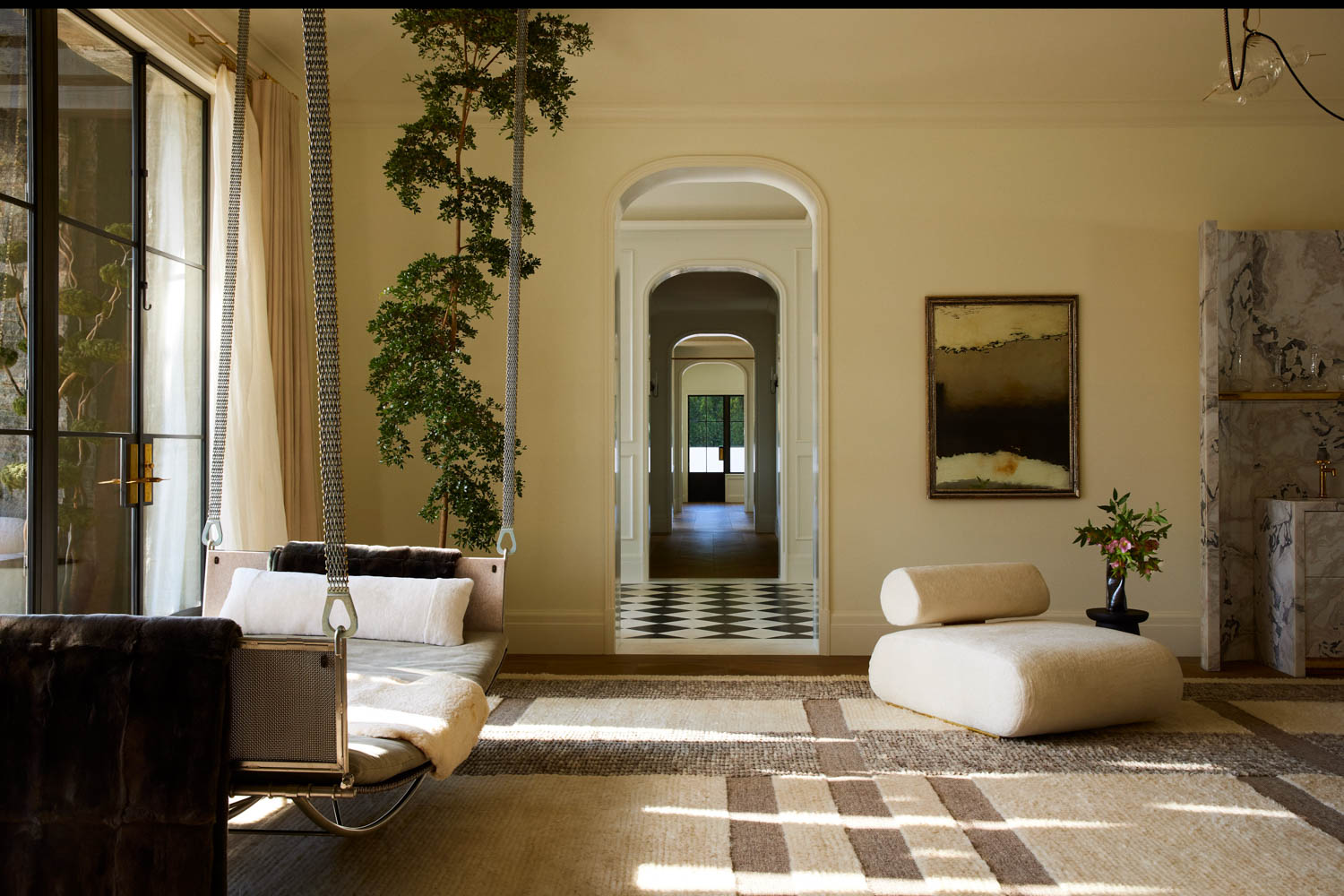 yellow living area with views of a checkerboard hallway