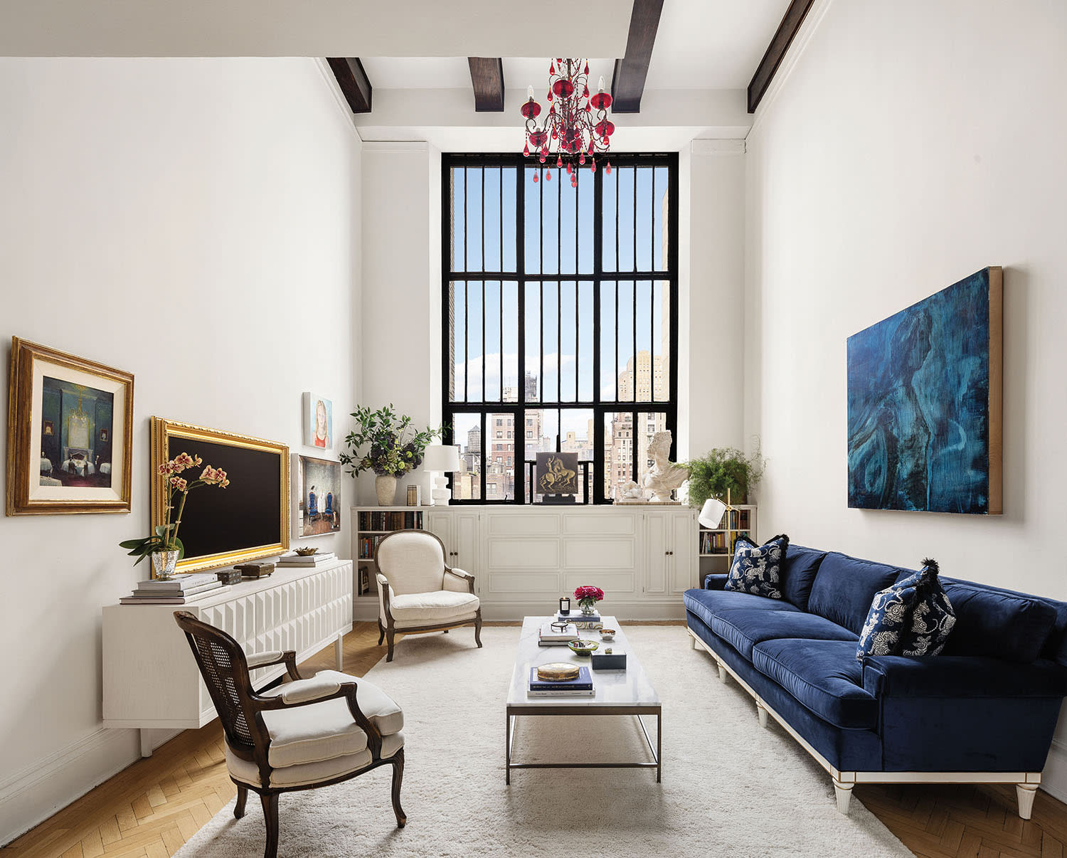 modern white living room with a blue sofa