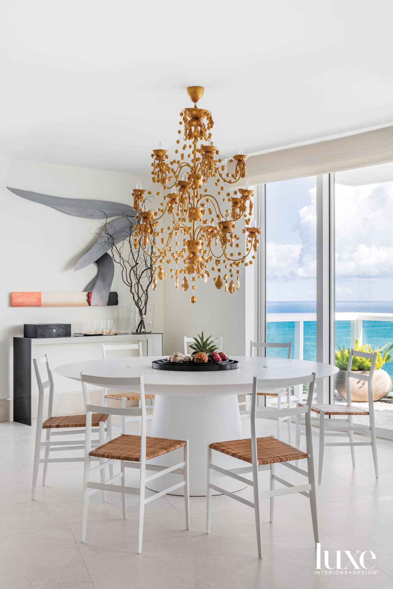 dining area with terra-cotta chandelier and white round table