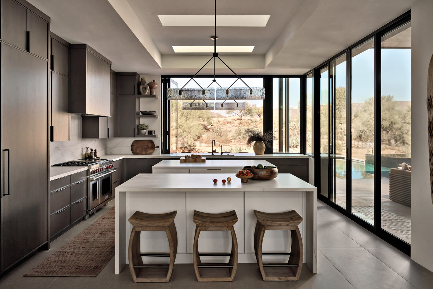 contemporary kitchen with white double islands and dark wood cabinetry