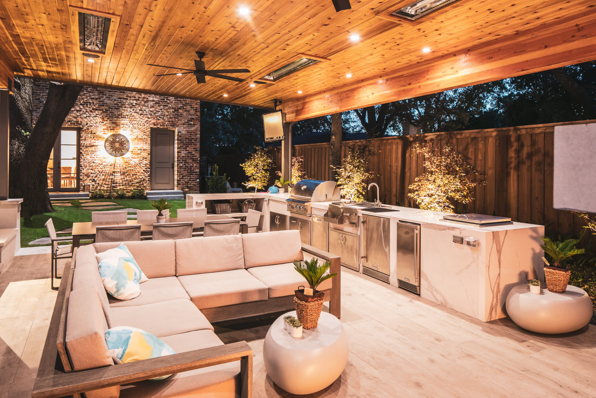 Outdoor living space with wood ceiling and full kitchen