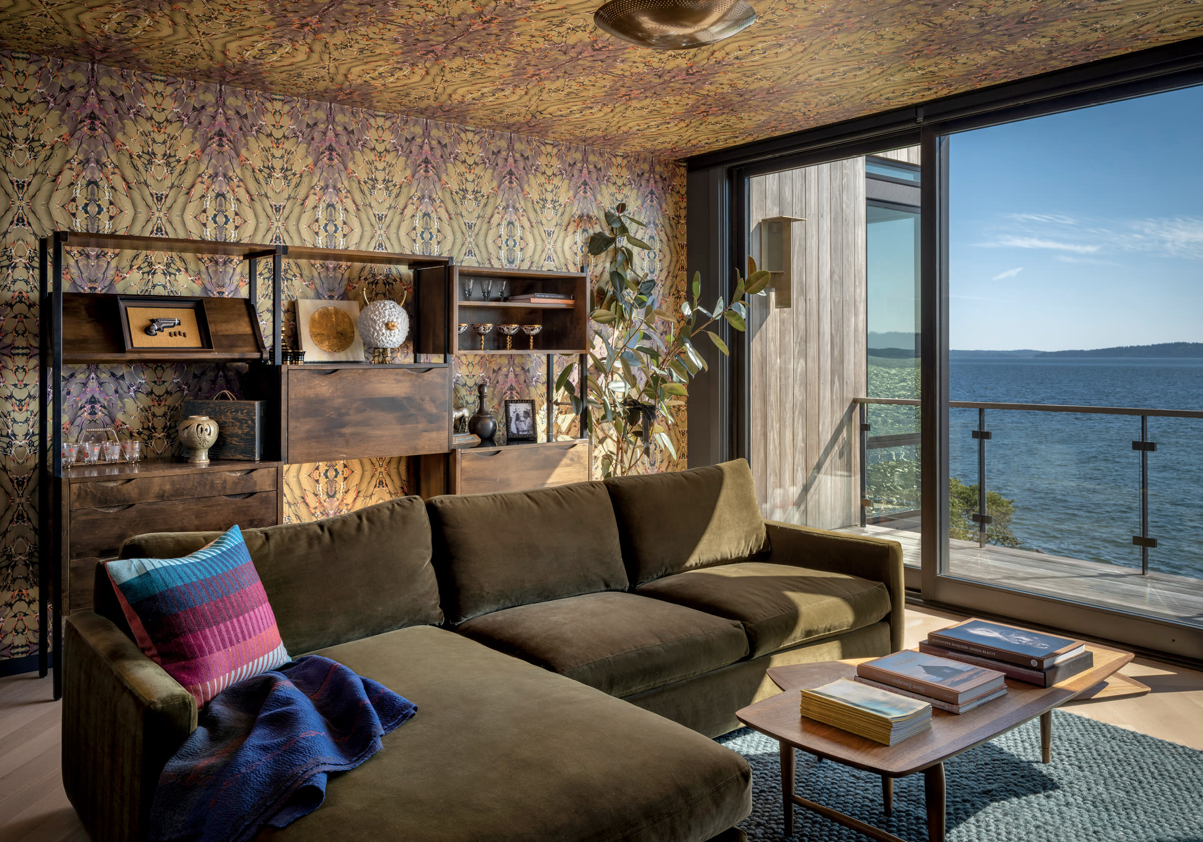 media room with eclectic yellow wallpaper and a dark green sofa