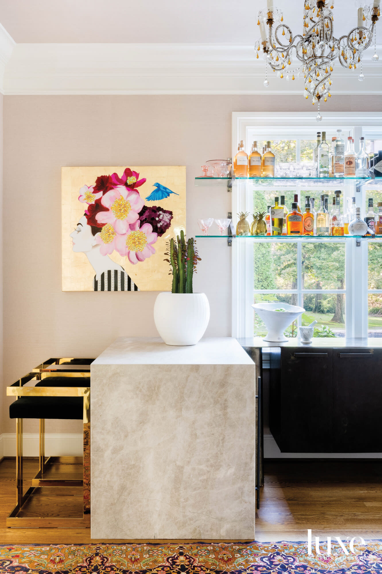 Bar with countertop, black stools, glass shelves and contemporary painting