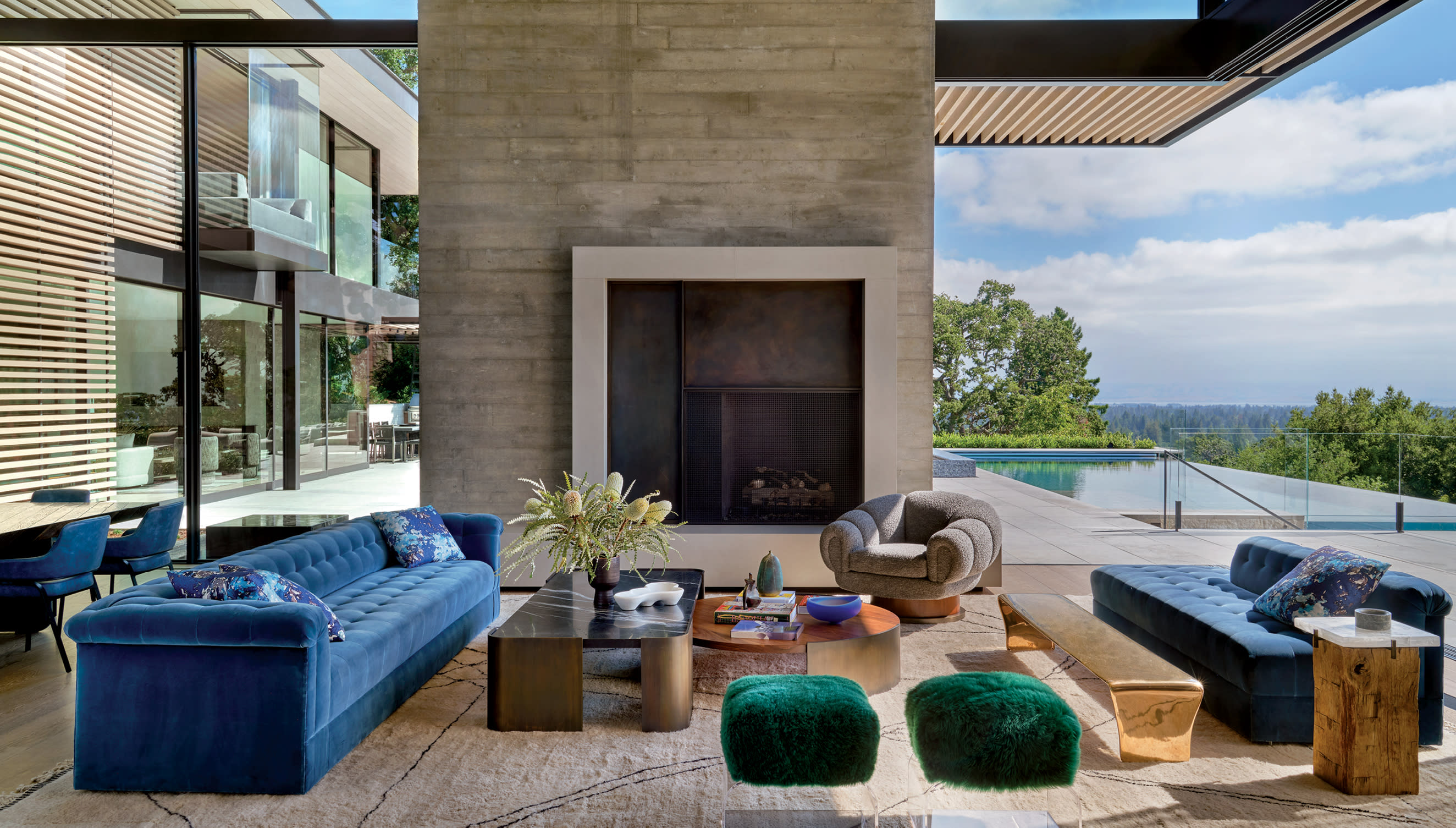 neutral living room with blue sofa and green ottomans