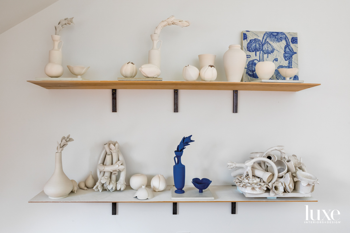 white and blue ceramic sculptures on shelf