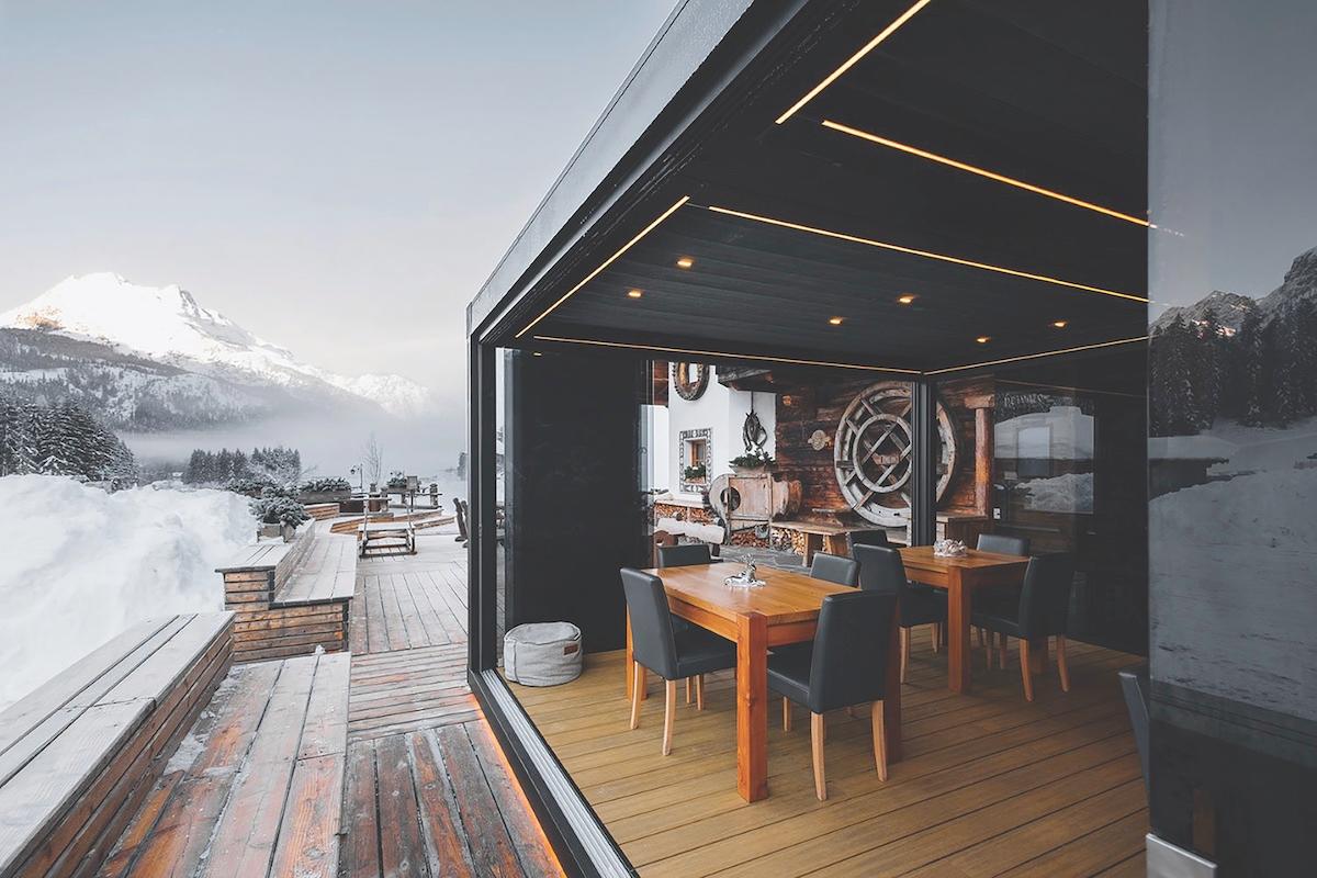 A restaurant featuring large windows that showcase a stunning view of surrounding mountains.