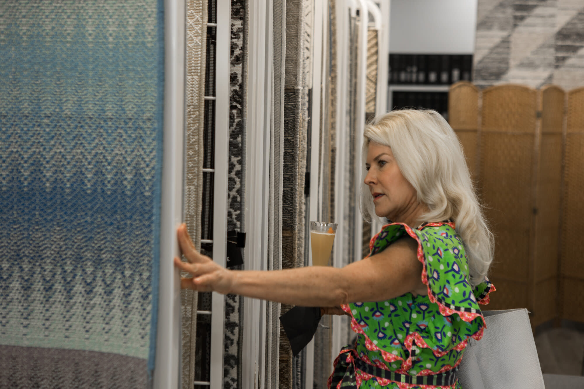 a lady looking at rugs