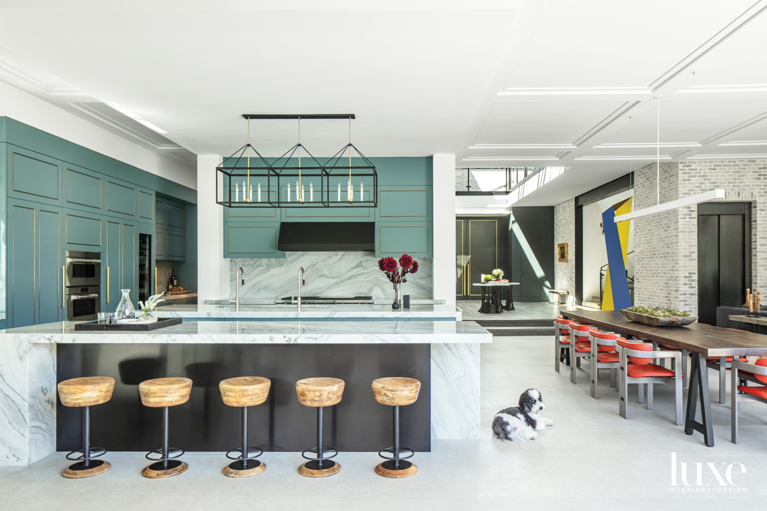 Wide view of kitchen featuring two islands with an adjacent dining area