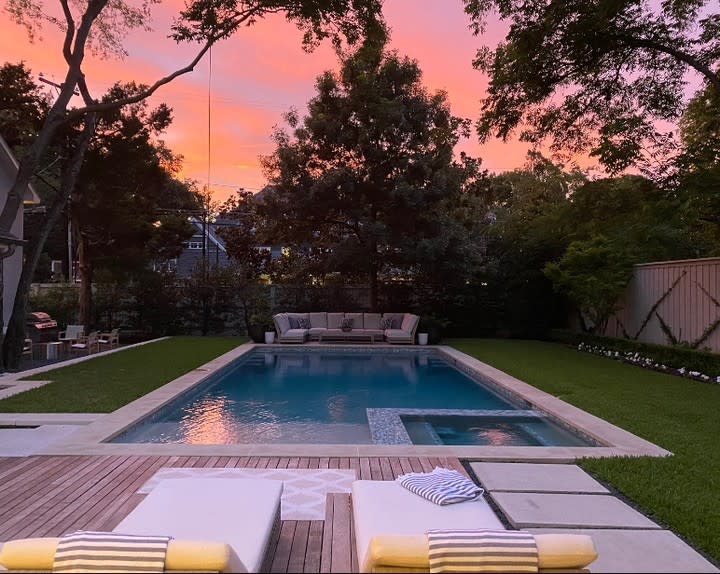 sunset view overlooking inground pool and lounge chairs