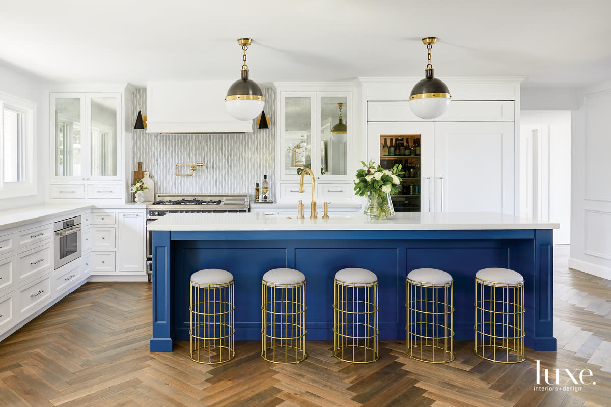 contemporary white kitchen blue island gold accents