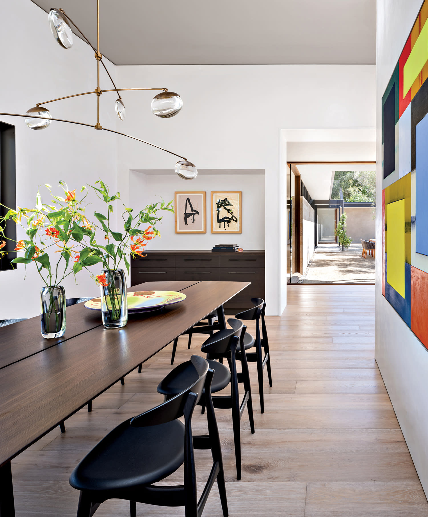 modern dining room with colorful artwork on one wall