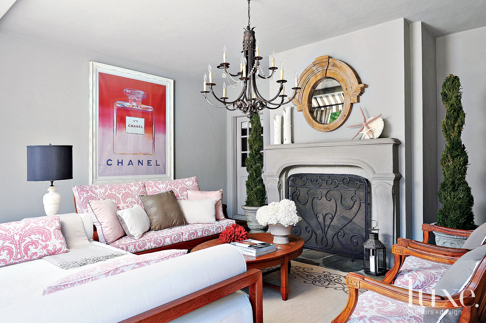 bedroom with pink Andy Warhol Chanel poster and pillows