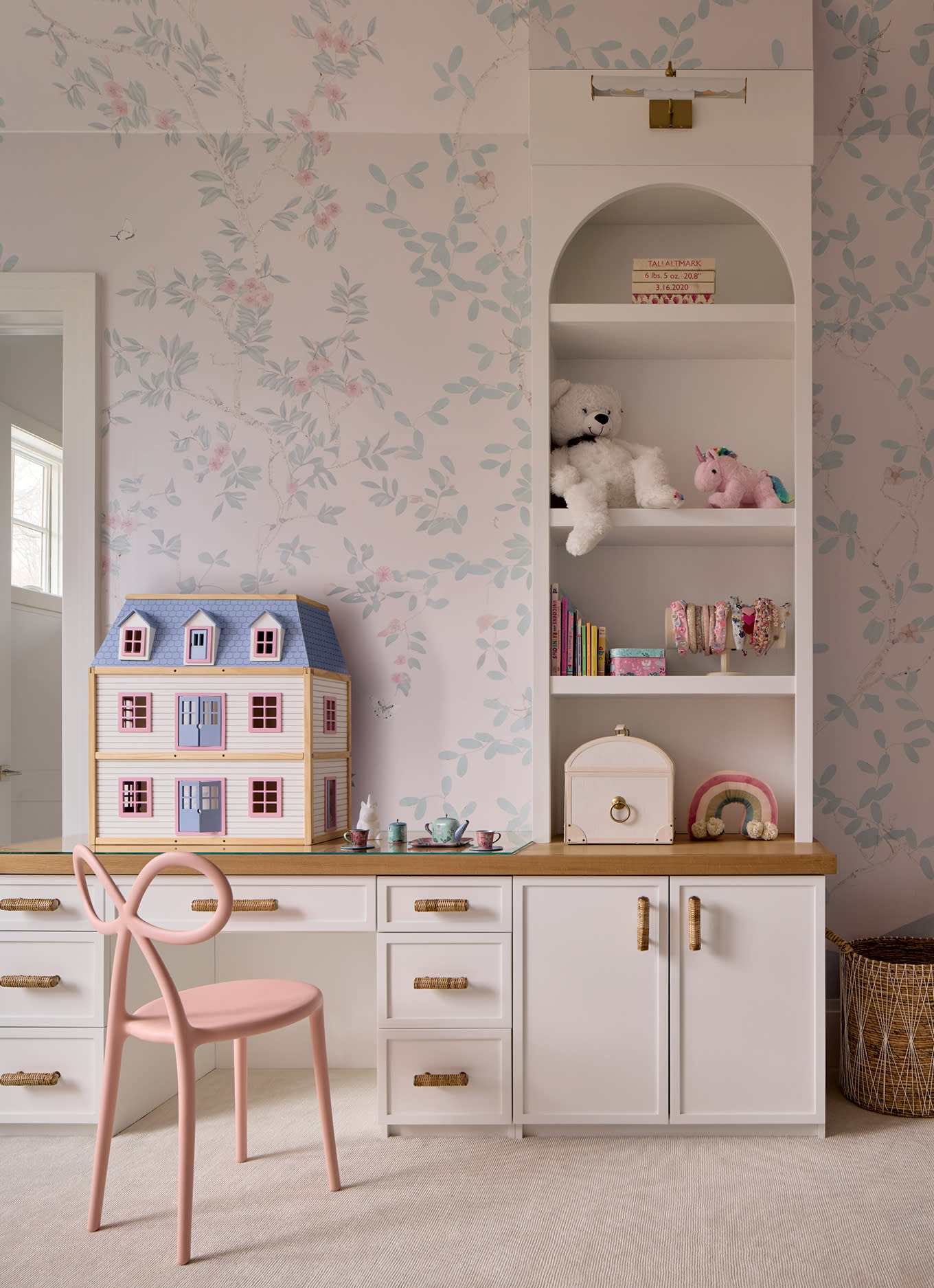 arched niche shelf above a desk in a whimsical pink bedroom