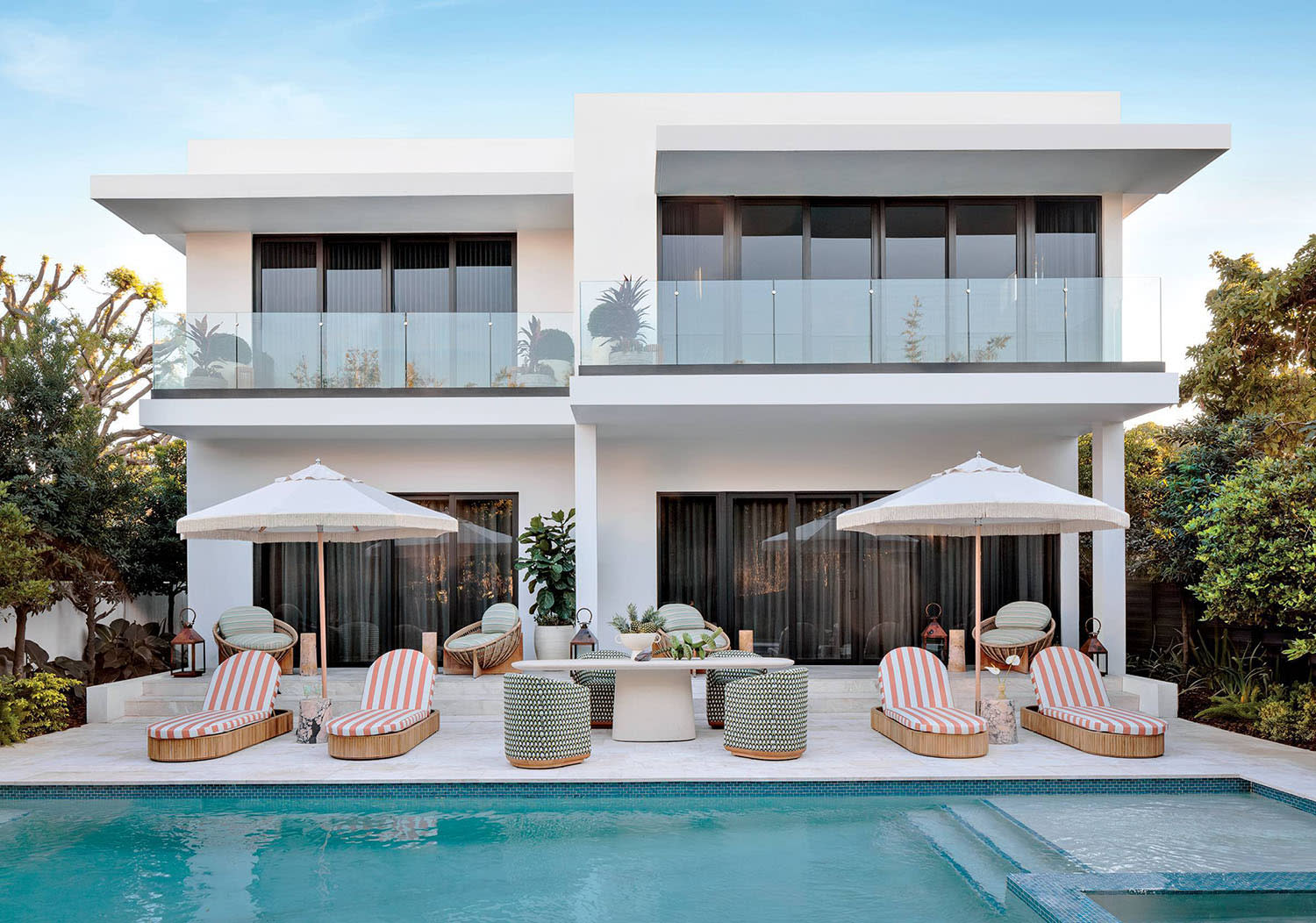 modern home exterior fronted by a luxury pool