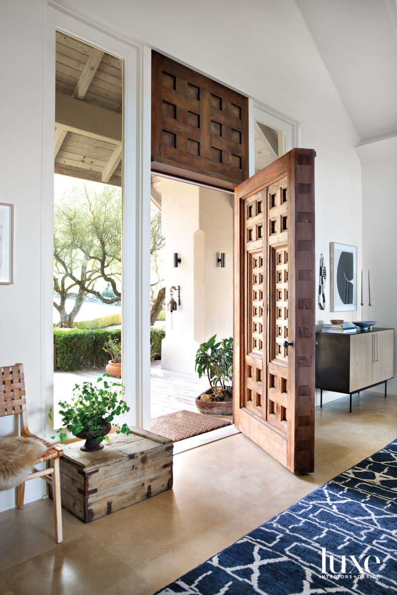 A large, carved door is at the front of the house.