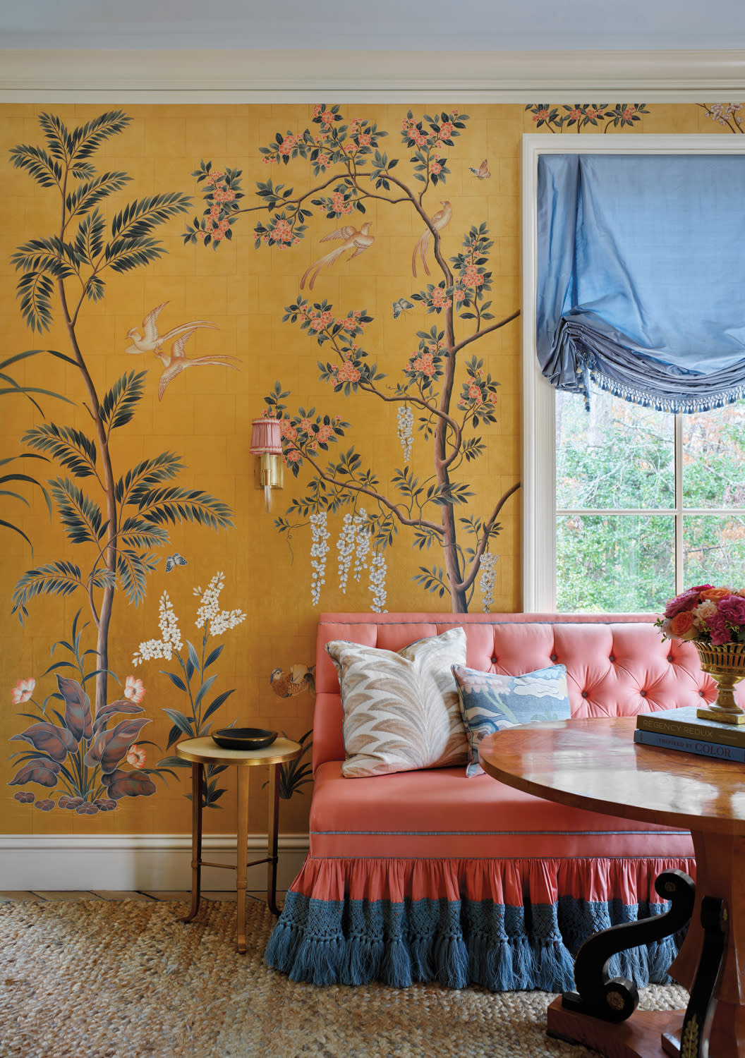 room with yellow wallpaper with tree and floral motifs