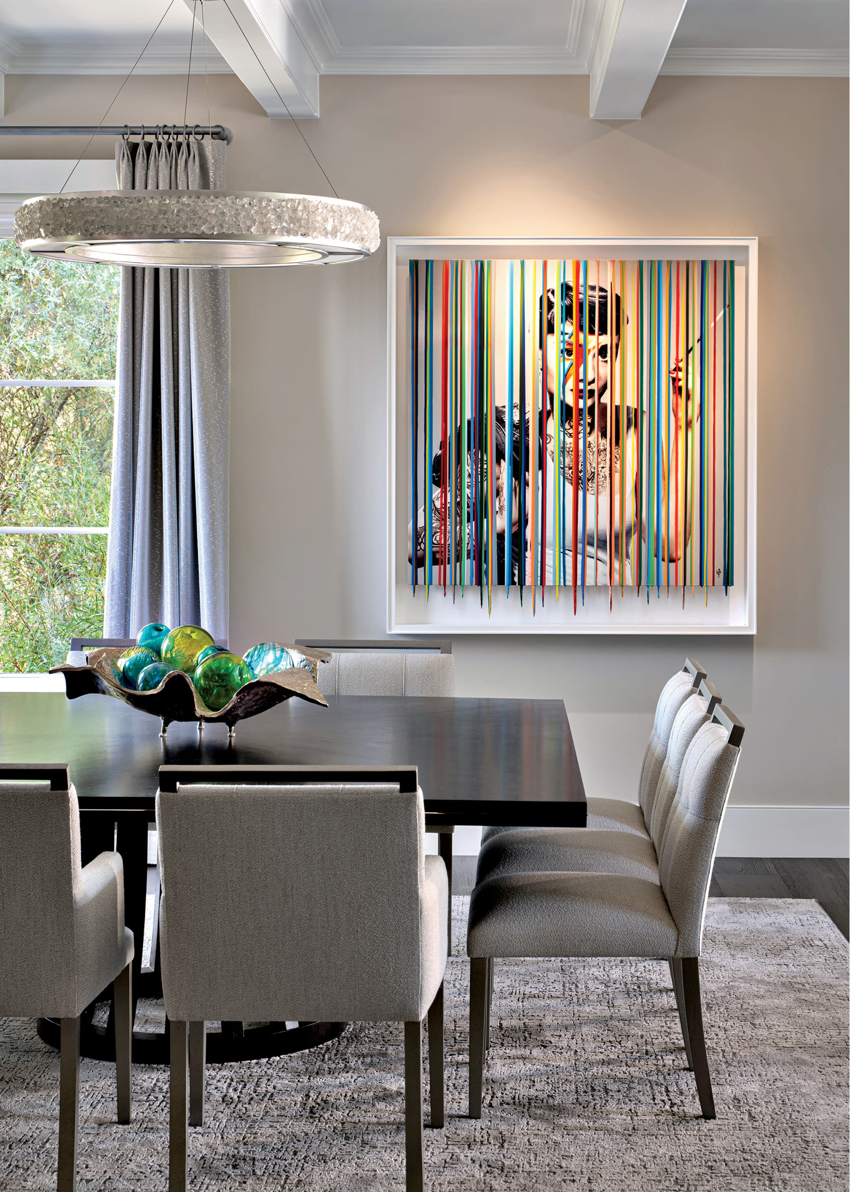 grey dining room with a colorful abstract artwork as the focal point