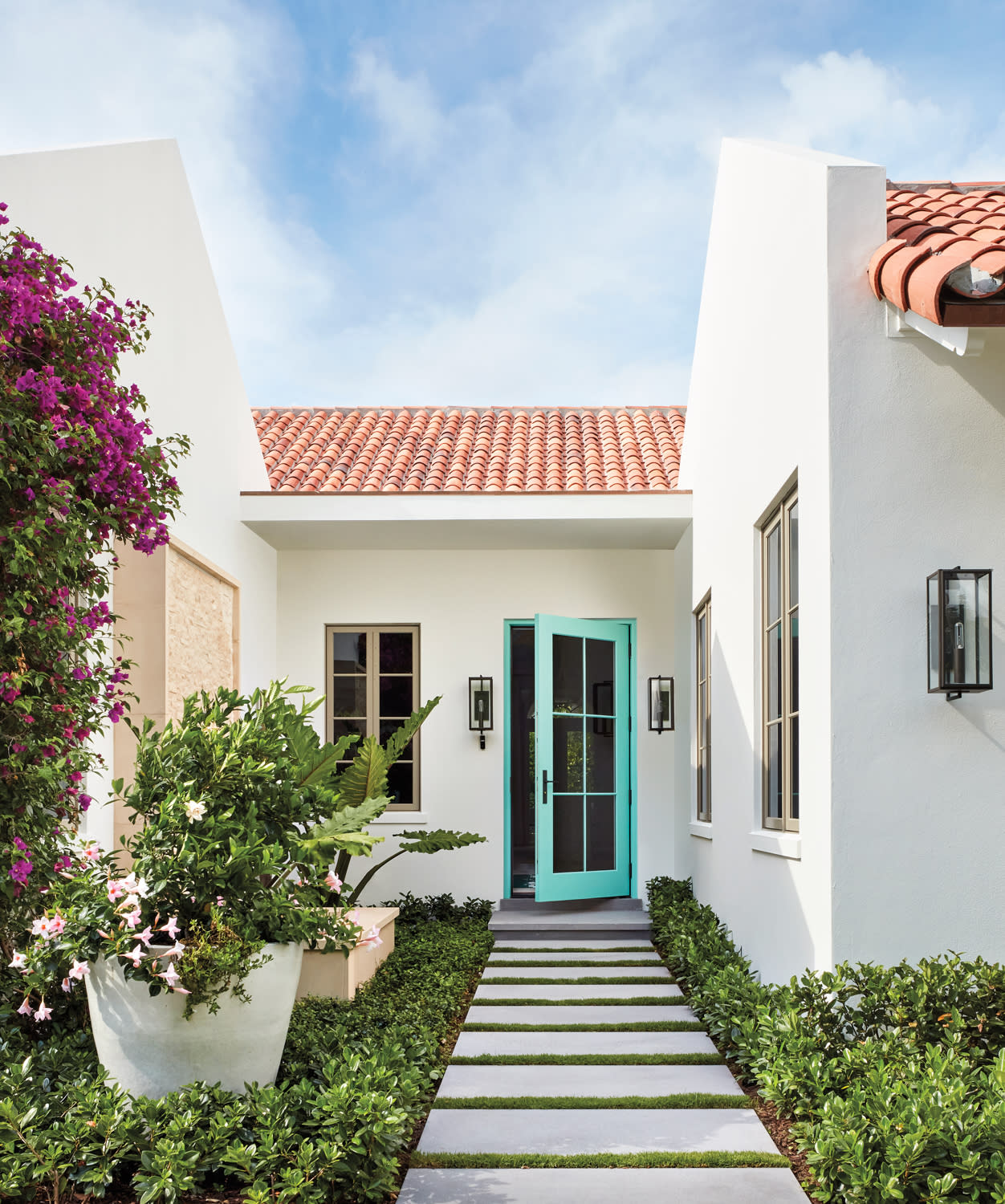 front entrance of mediterranean-style one-story home with teal front door