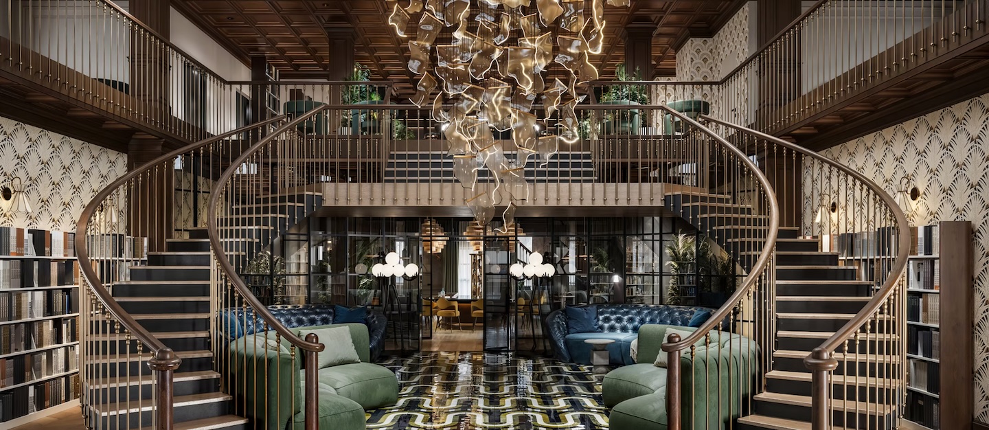 Elegant living room with a grand double staircase, modern chandelier, and luxurious seating. Sophisticated, warm ambiance with geometric patterned floor.