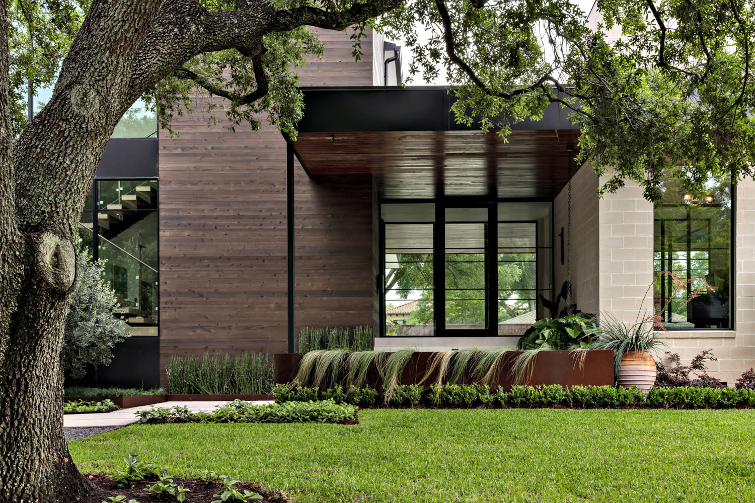 oversize masonry and wood make up the exterior architecture of this Houston home 