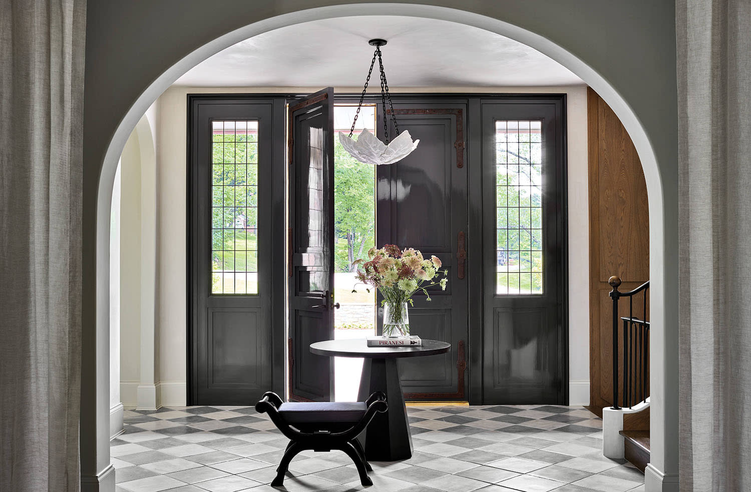 traditional entryway with stone flooring and arched wall