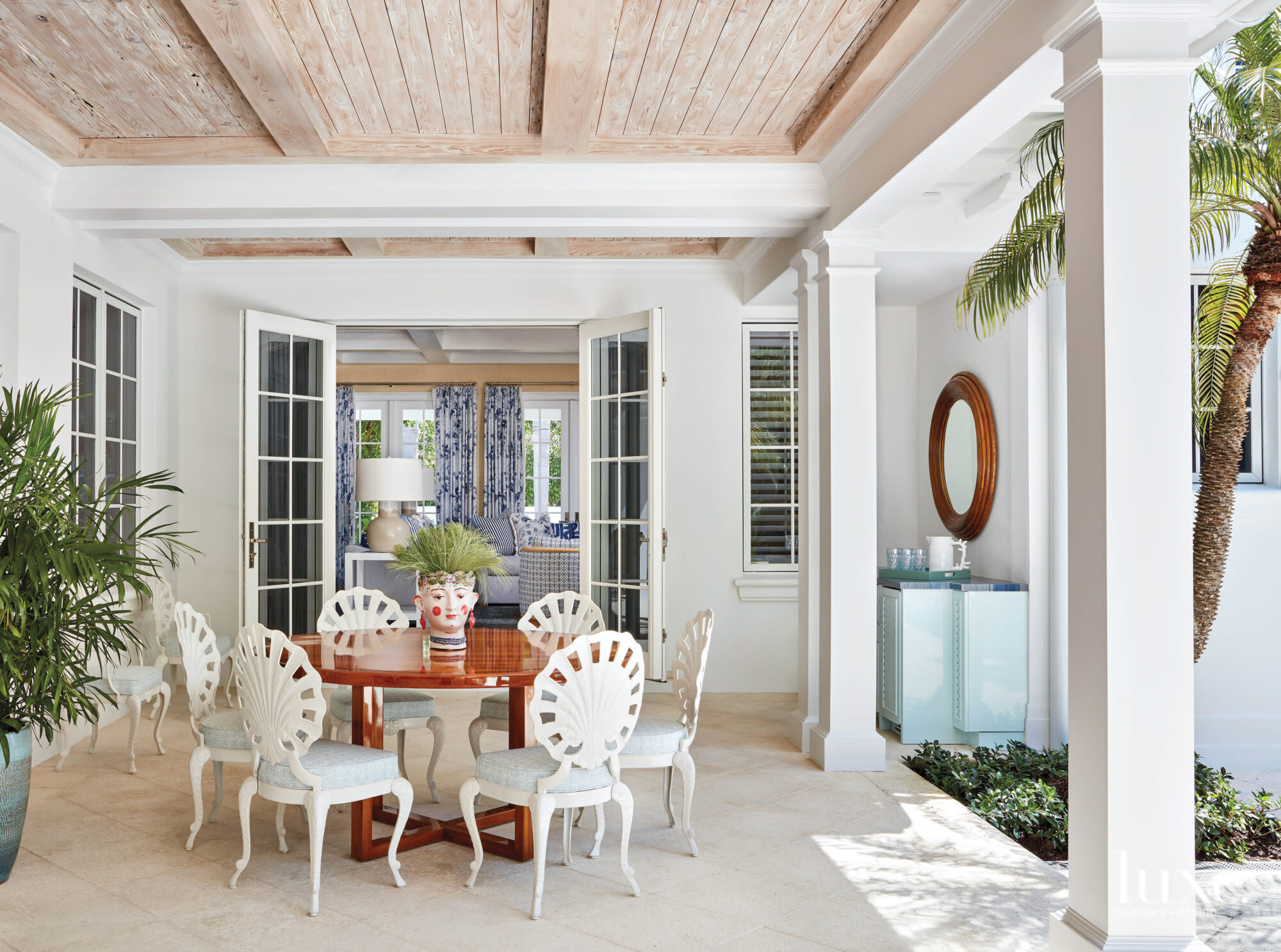 Loggia with vintage grotto chairs and a teak table.