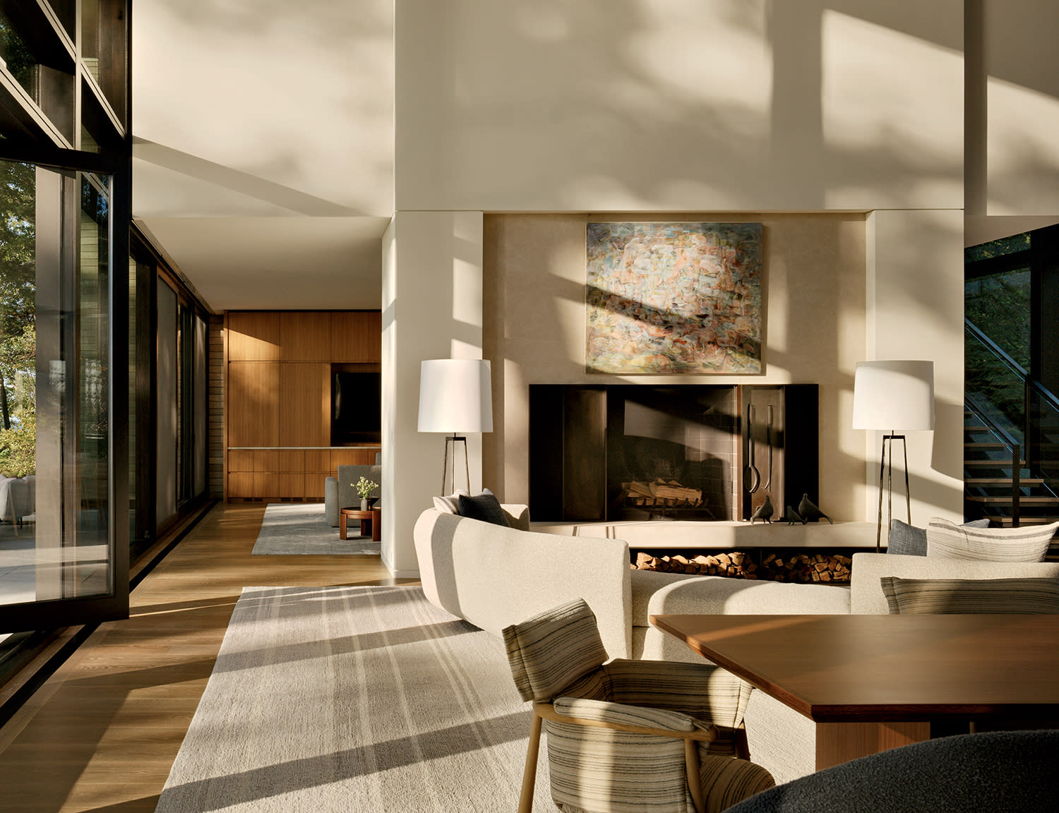 neutral living room with a fireplace topped by an abstract artwork