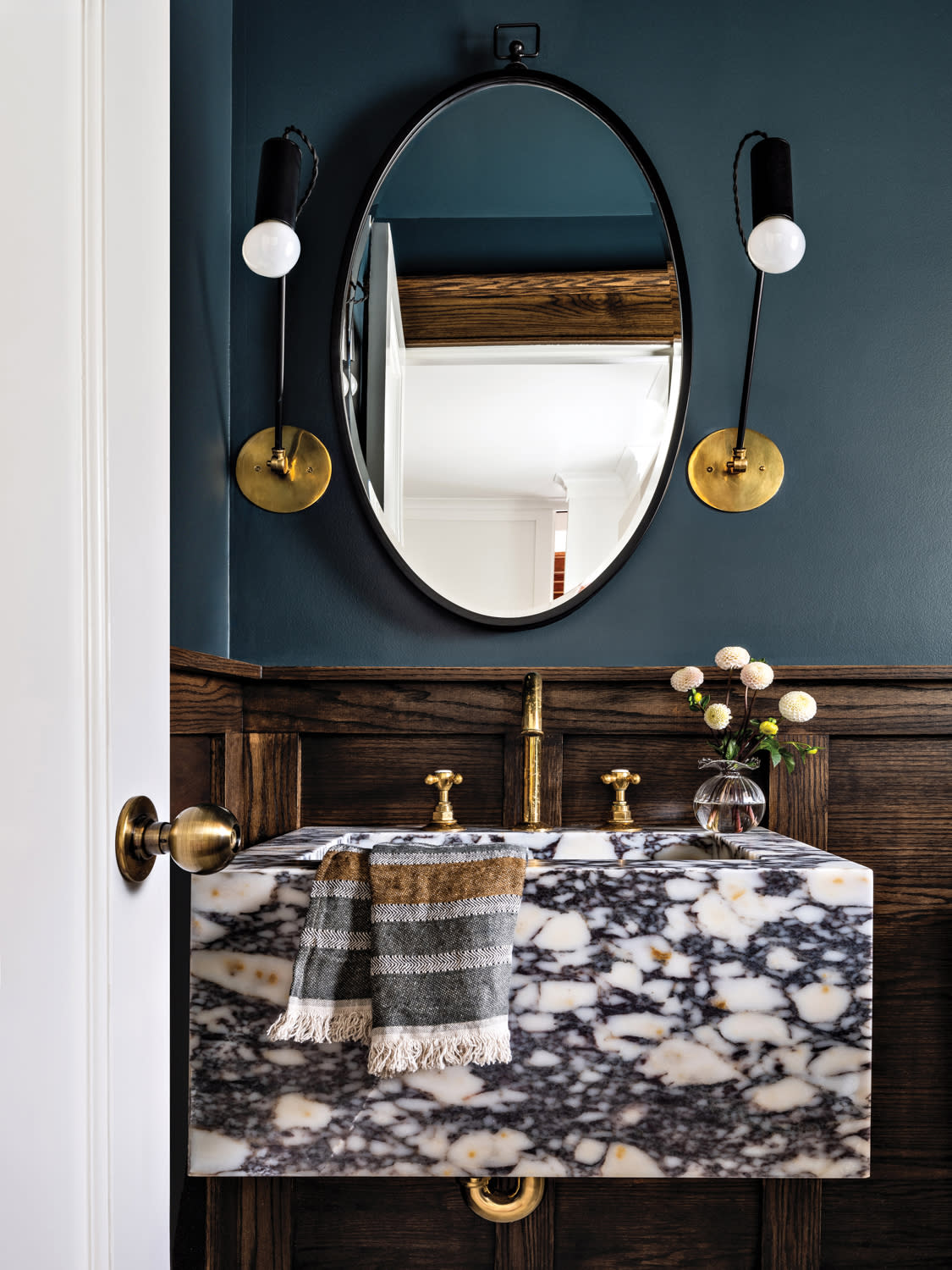 dark blue powder room with a Calacatta Viola marble sink