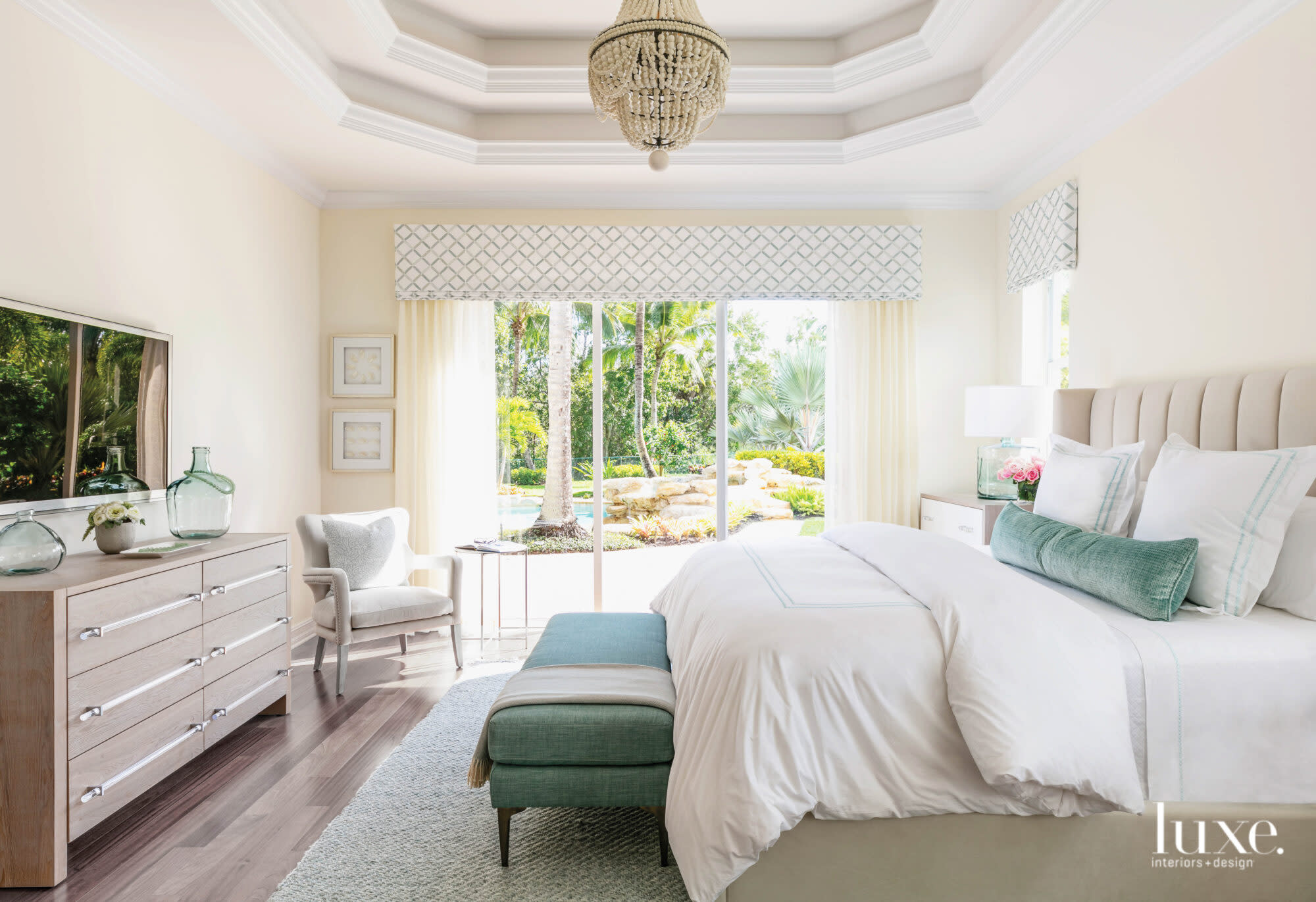 bedroom with white bead, teal accents and beaded chandelier