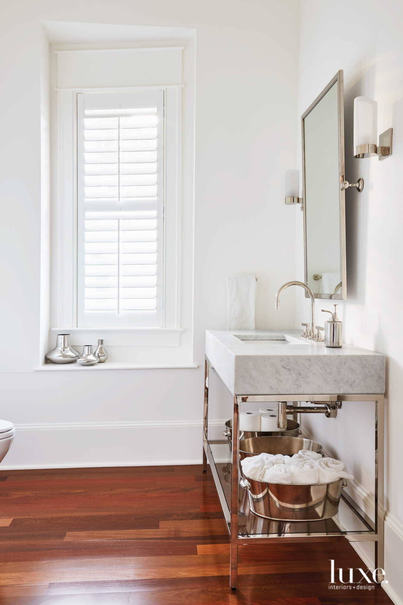 Powder room with ipe floors marble-top vanity.