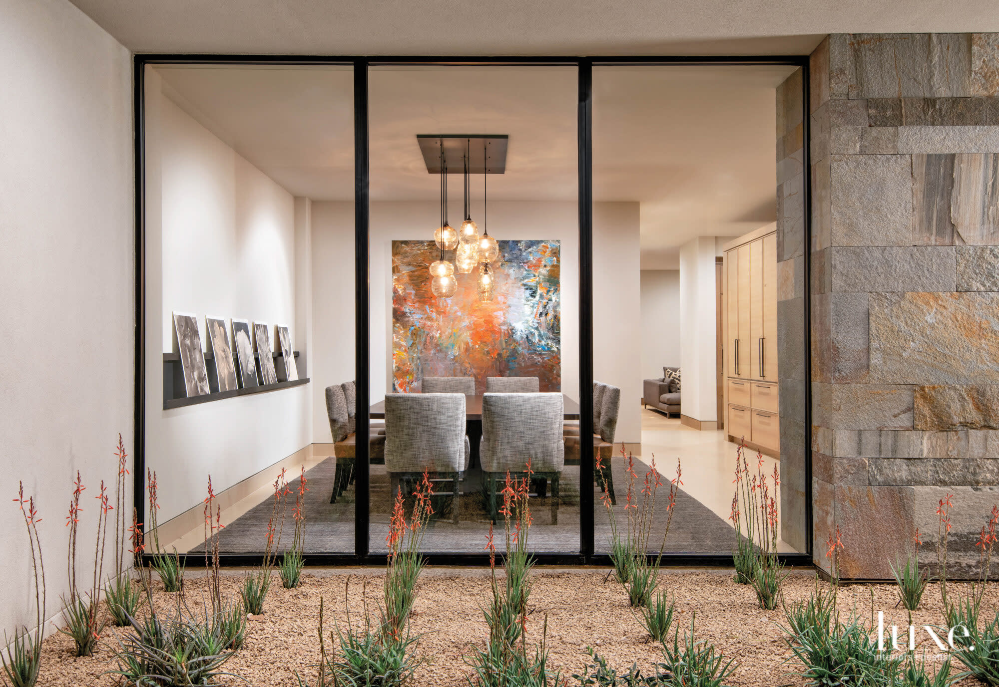 A view of the living room with a brightly colored abstract painting by Patrick Adams.