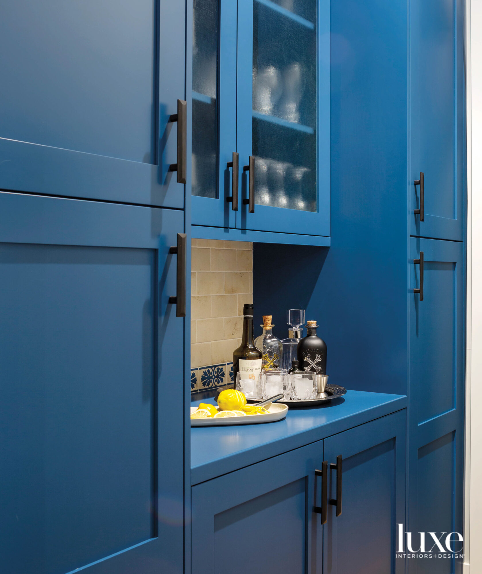 The pantry has bright blue cabinetsl